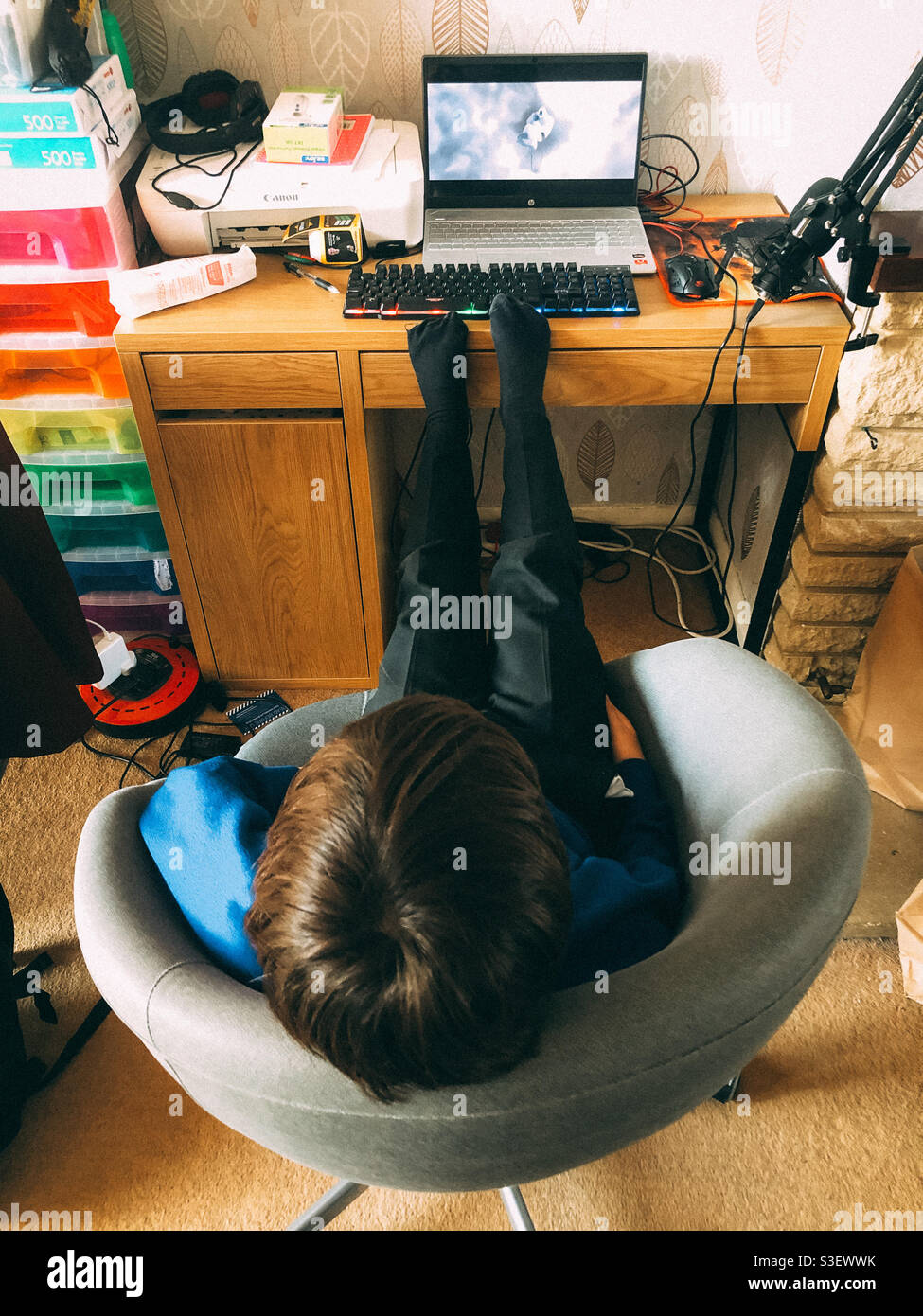 A child relaxing and watching a film on a laptop computer. - Smartphone Captured Stock Image