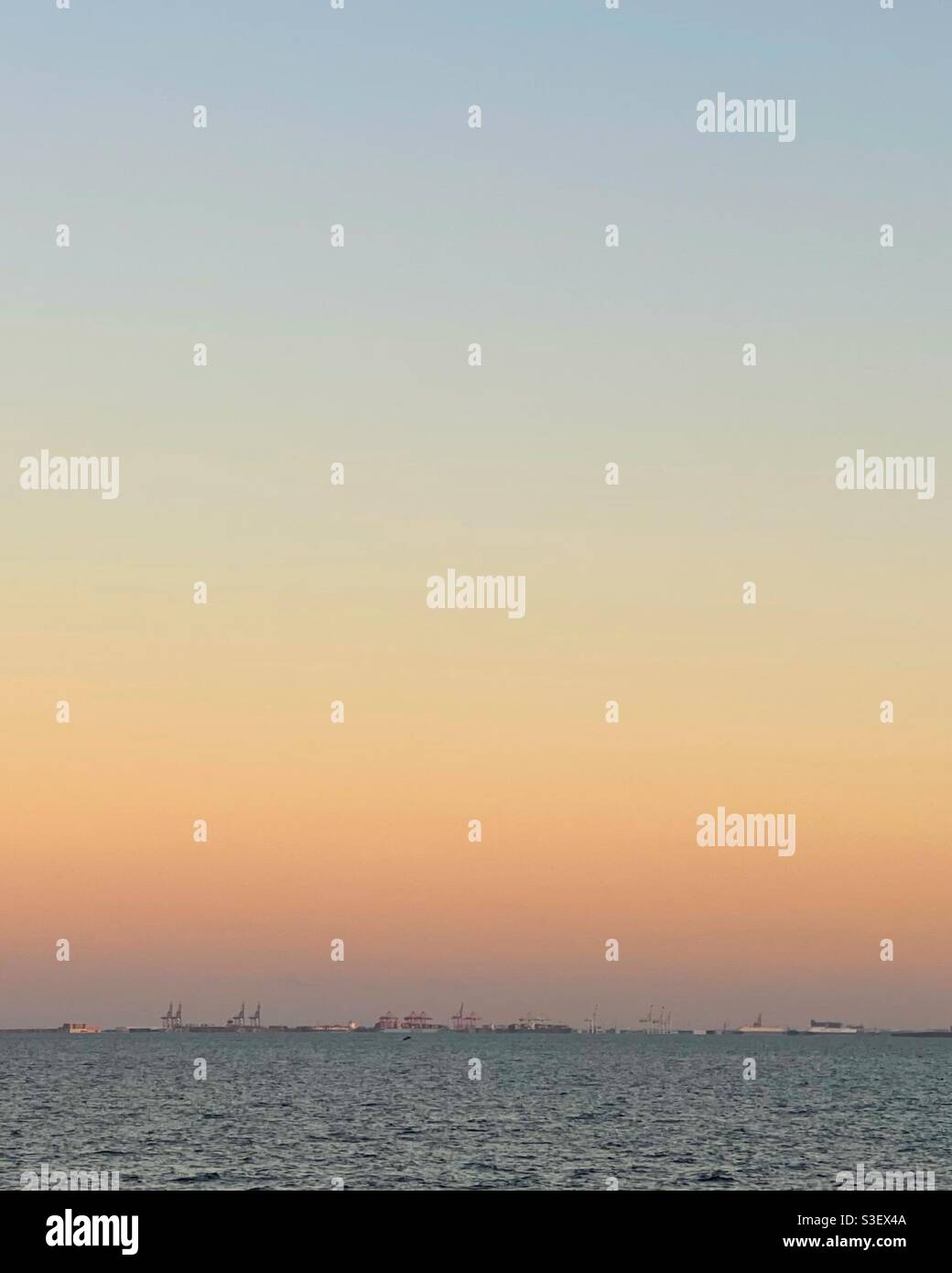 Long distance view of Brisbane Port from Margate Beach at sunset - Smartphone Captured Stock Image