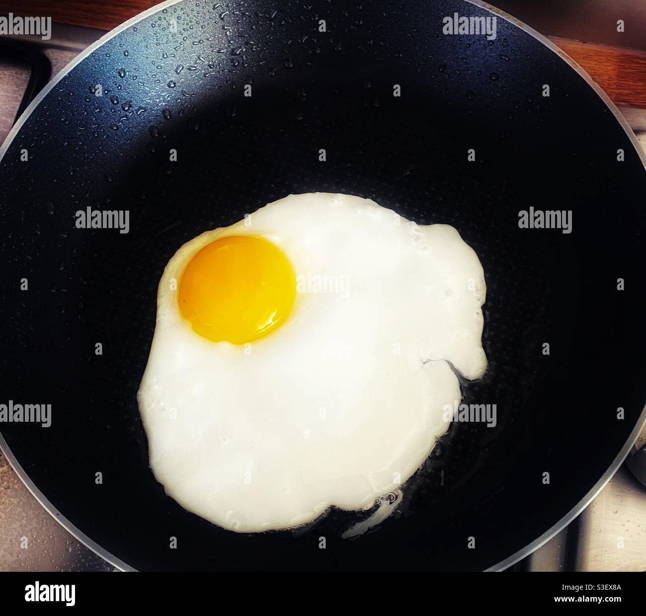 A close up photograph of a fried egg in a frying pan - Smartphone Captured Stock Image