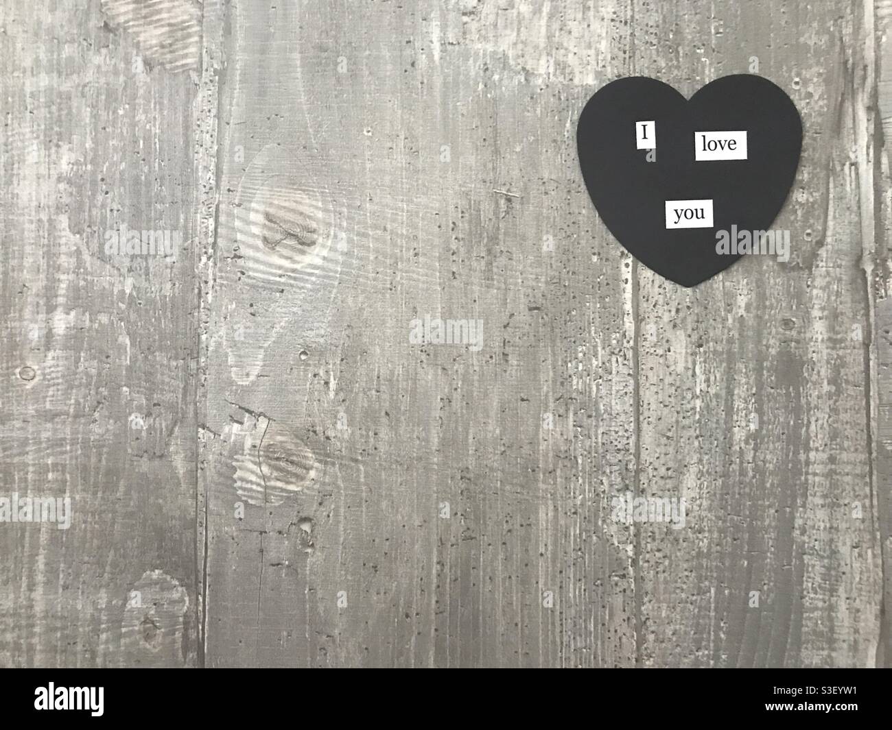 I love you heart sign against a wooden background - Smartphone Captured Stock Image