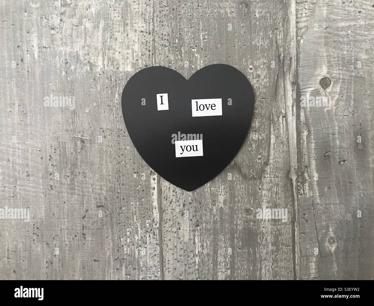 I love you heart sign against a wooden background - Smartphone Captured Stock Image