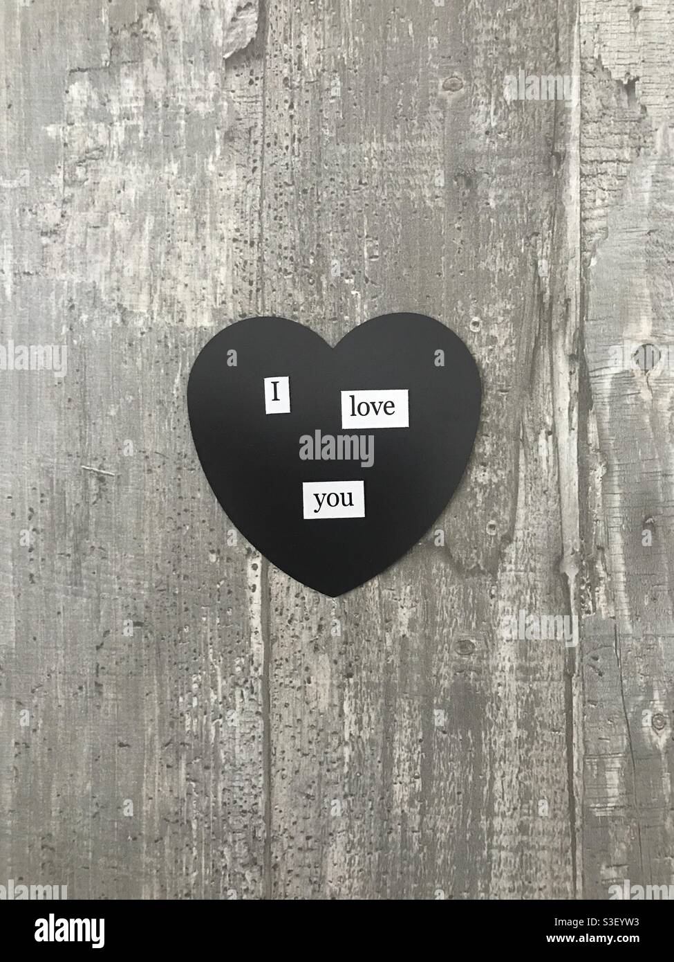 I love you heart sign against a wooden background - Smartphone Captured Stock Image