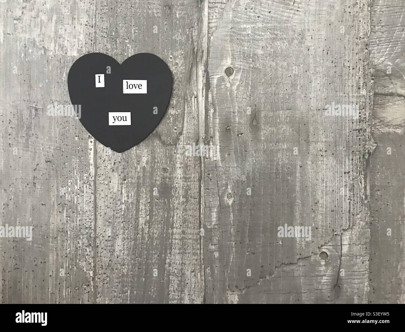 I love you heart sign against a wooden background - Smartphone Captured Stock Image