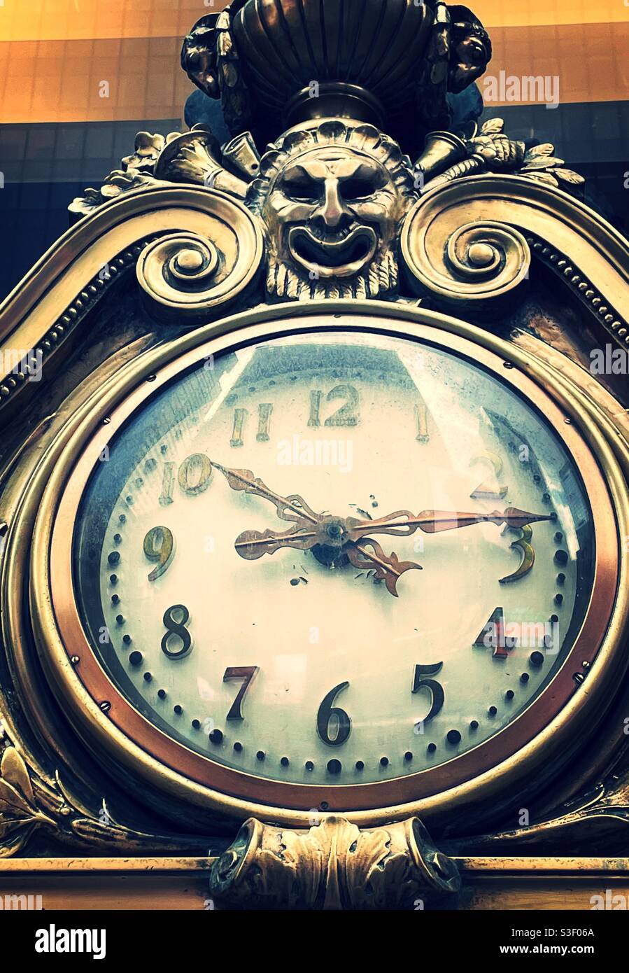 Ornate analog clock face on the front entrance to the Paramount building in Times Square,, NYC, USA - Smartphone Captured Stock Image