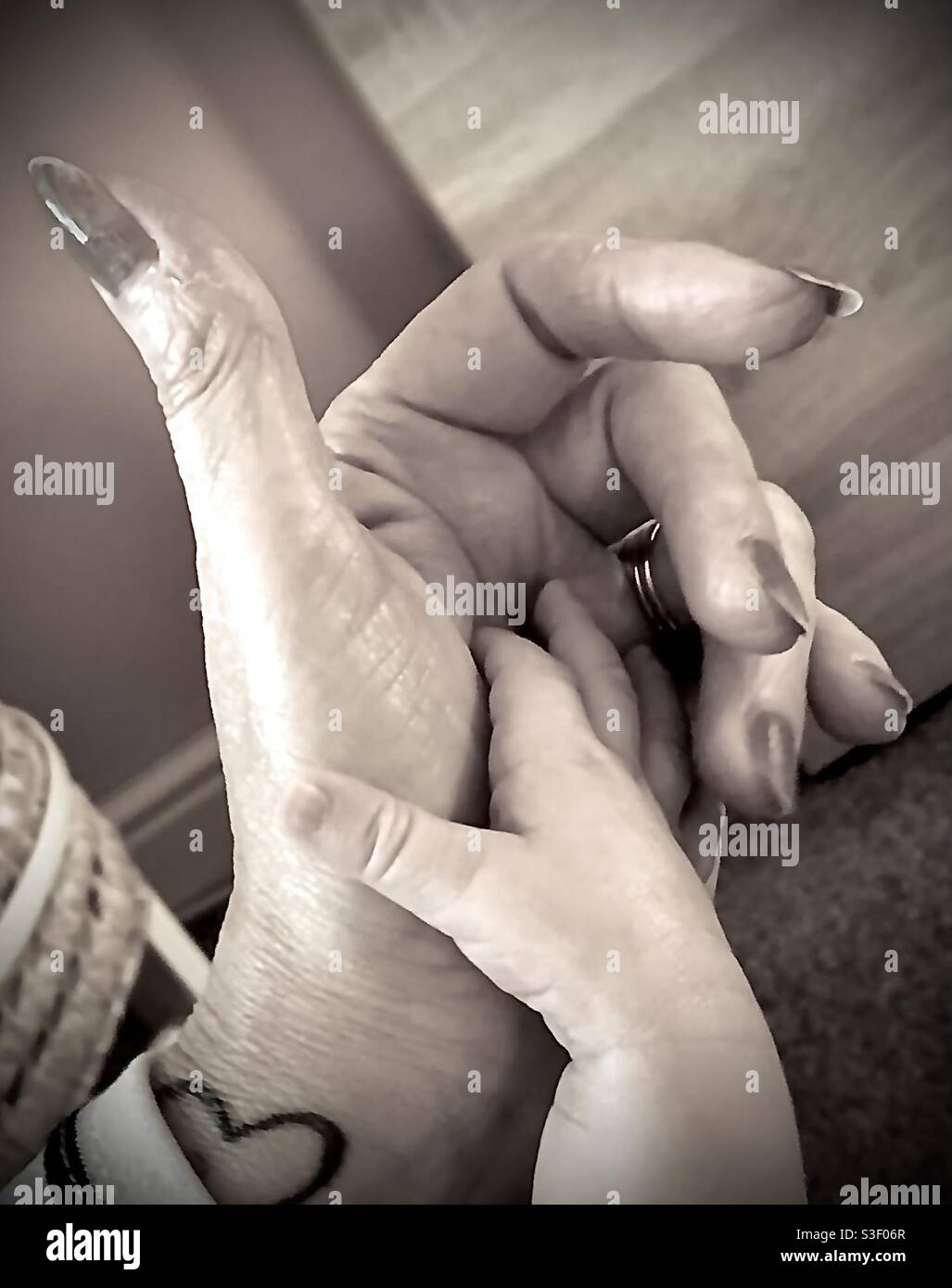 Baby & Grandma hands Stock Photo