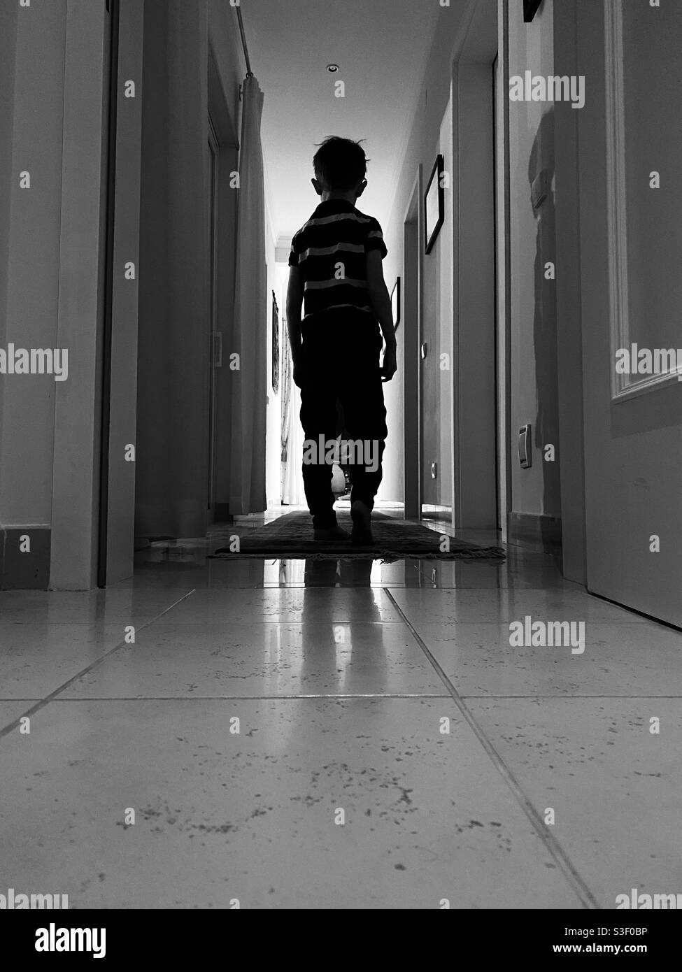 Low angle view of child in a dark corridor - Smartphone Captured Stock Image