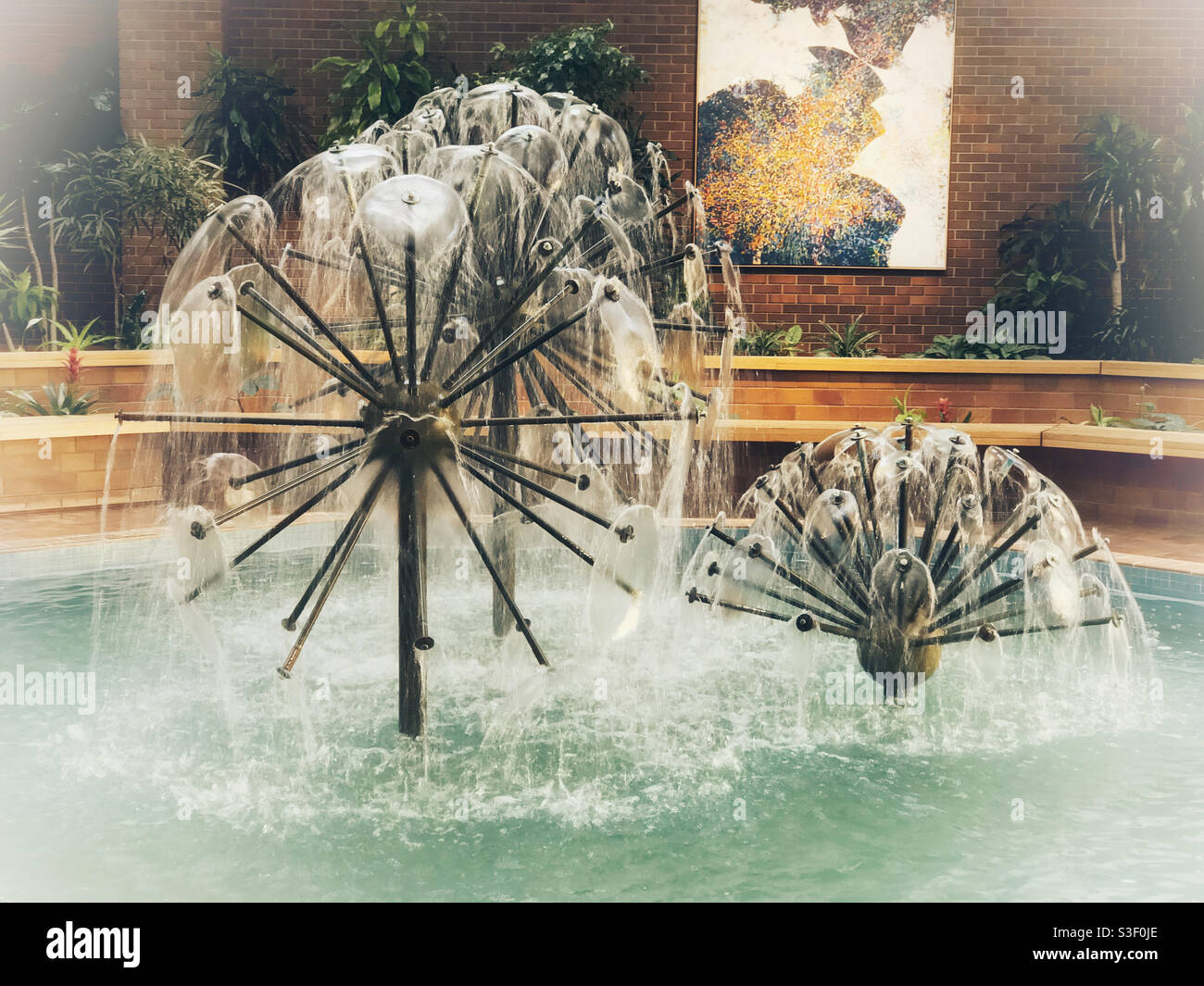 Fountains in an indoor gathering space in the downtown Plus15 walkway