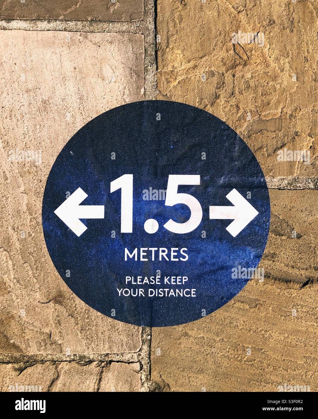 Social distancing sign on the pavement - Smartphone Captured Stock Image