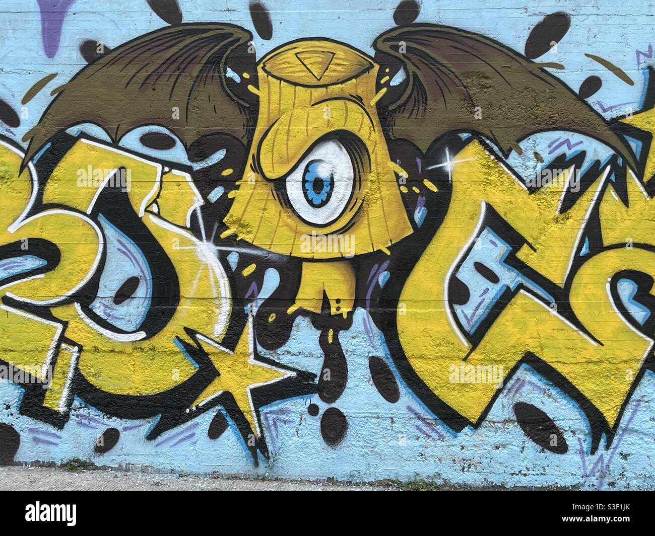 Flying eye, creative murales on a city wall Stock Photo