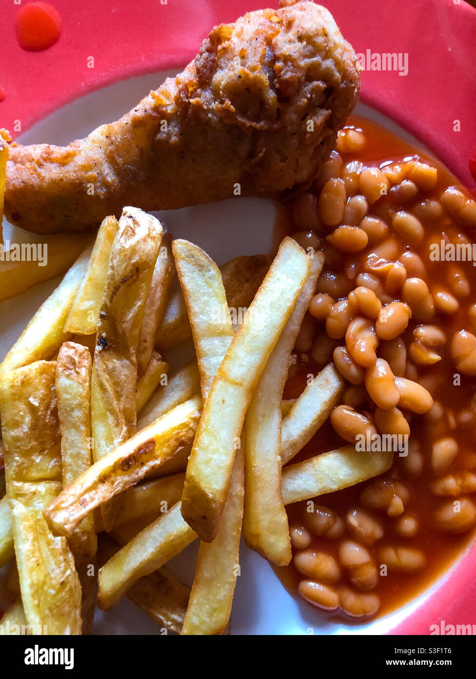 Fried chicken with chips and baked beans on a plate for dinner - Smartphone Captured Stock Image