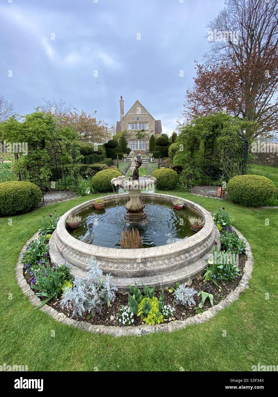 Elevated view of a beautiful garden and fountain in springtime Stock Photo
