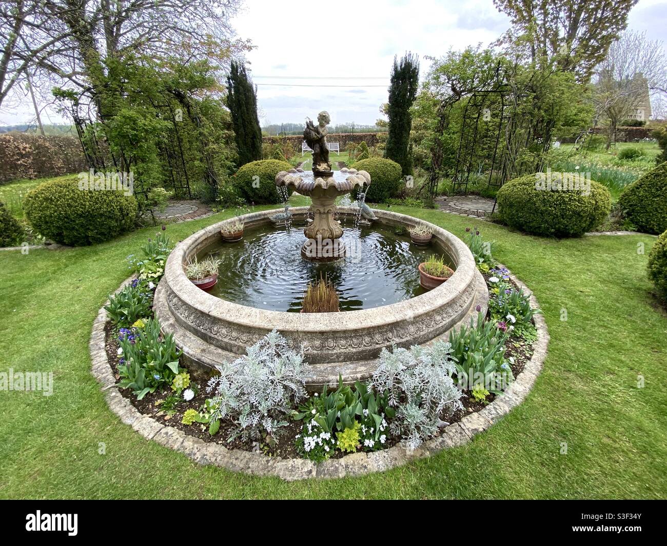 Elevated  view of a formal garden and a fountain in springtime Stock Photo