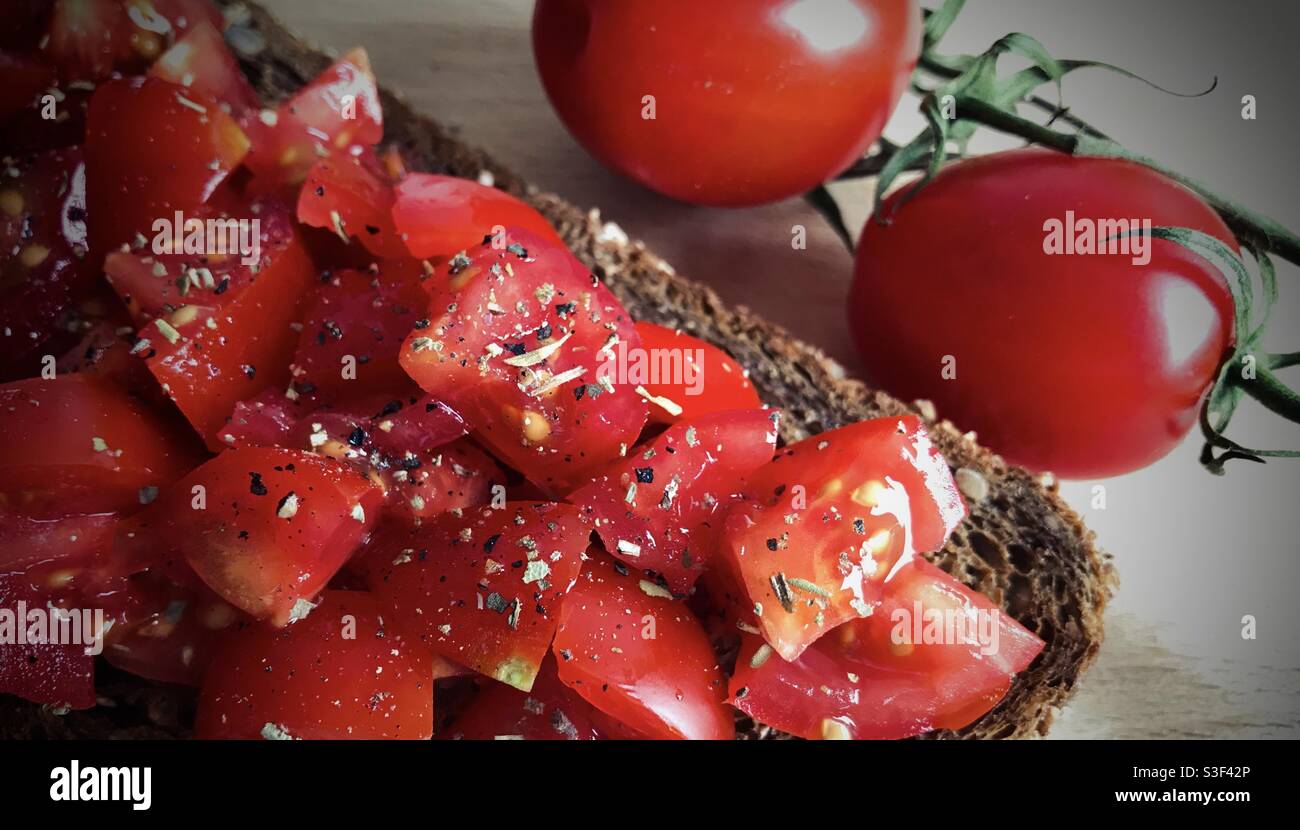 Close-up of Mediterranean toast with sweet tomatoes and olive oil - Smartphone Captured Stock Image