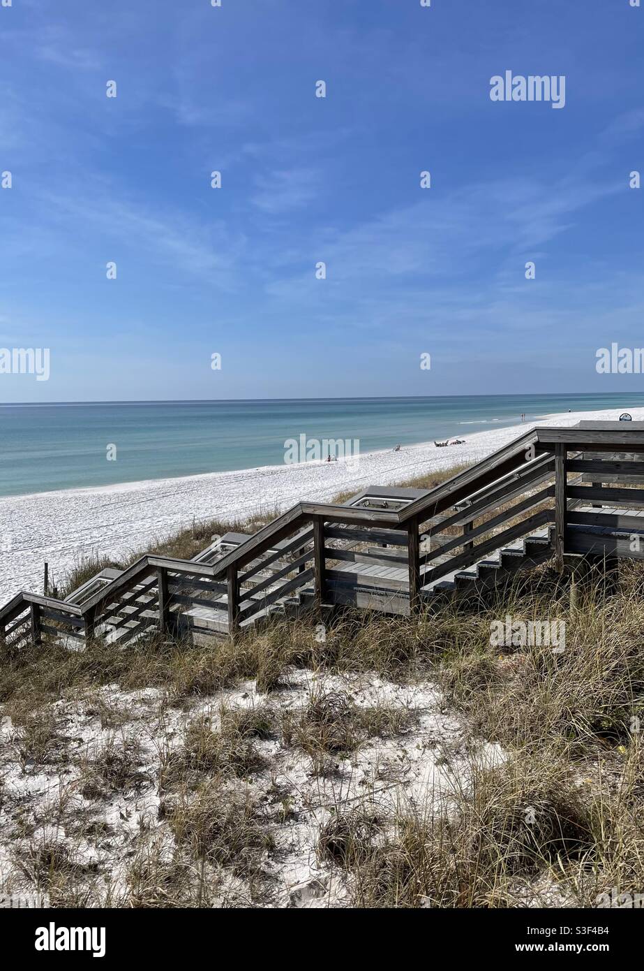 Long wooden bridge walkway leading to Florida white sand beach - Smartphone Captured Stock Image