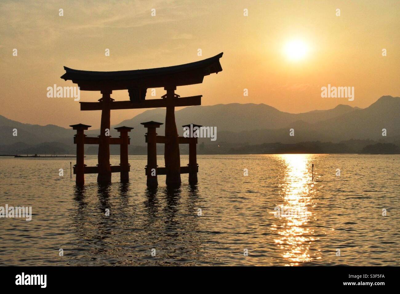 Floating Torii Gate at Itsukushima Shrine on Miyajima Island, Hiroshima, Japan - Smartphone Captured Stock Image Floating Torii Gate at Itsukushima Shrine on Miyajima Island, Hiroshima, Japan - Smartphone Captured Stock Image