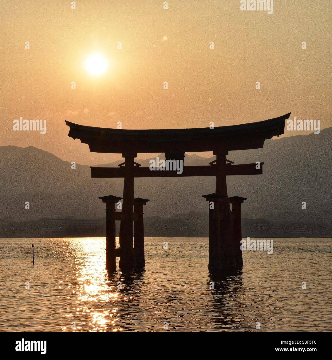 Floating Torii Gate at sunset, Itsukushima Shrine on Miyajima Island, Hiroshima, Japan - Smartphone Captured Stock Image