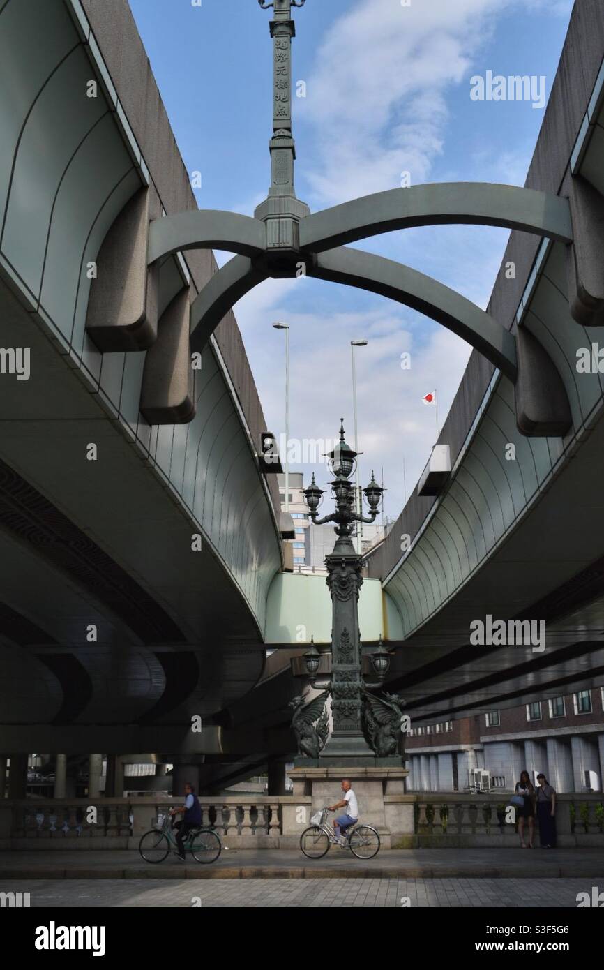 A man on a bicycle crossing the Edo Bridge in Tokyo, Japan - Smartphone Captured Stock Image