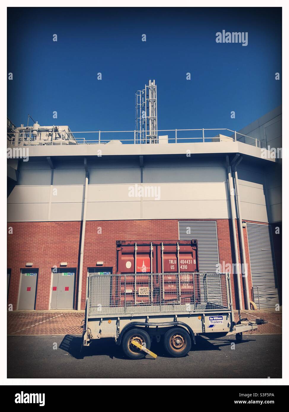Behind the scenes of the DG One sports centre in Dumfries, Scotland, showing an unglamorous view with a storage container. - Smartphone Captured Stock Image