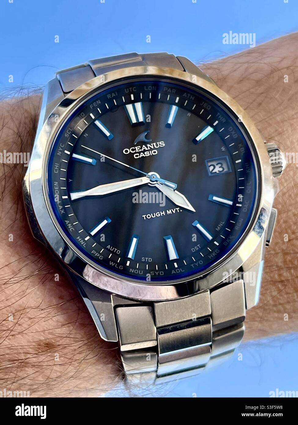 Casio S100 solar atomic titanium wrist watch with black dial, polished Chrome bezel and blue accents on a blue sky Stock Photo Alamy
