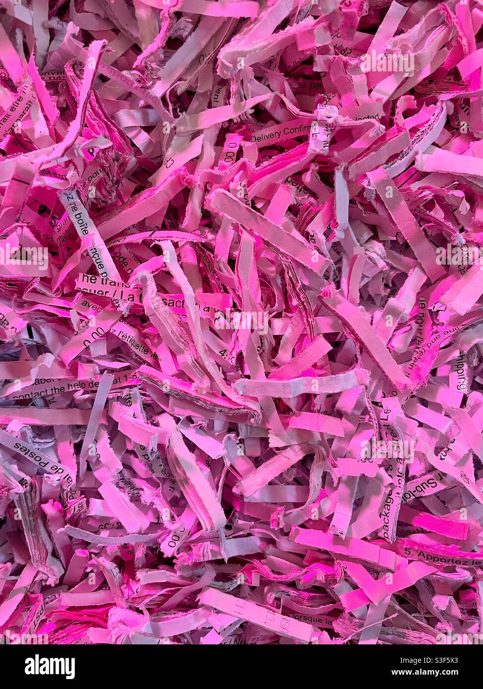 Shredded office paper under an led grow light. - Smartphone Captured Stock Image