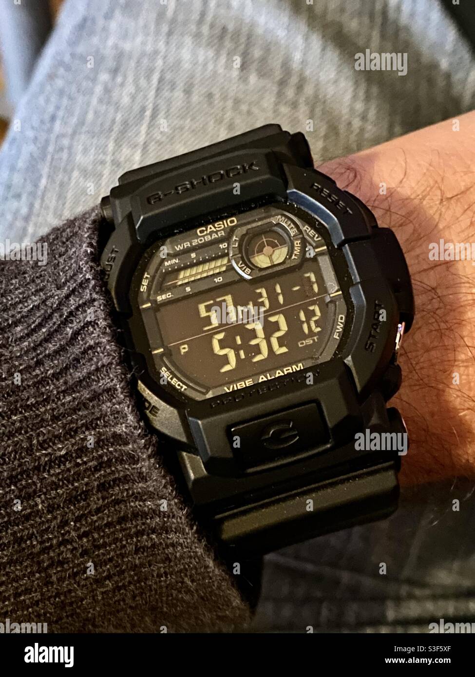 Casio G-SHOCK GD-350 Vibe Alarm digital wrist watch with negative display  on rubber strap and a sweater and blue jeans Stock Photo - Alamy