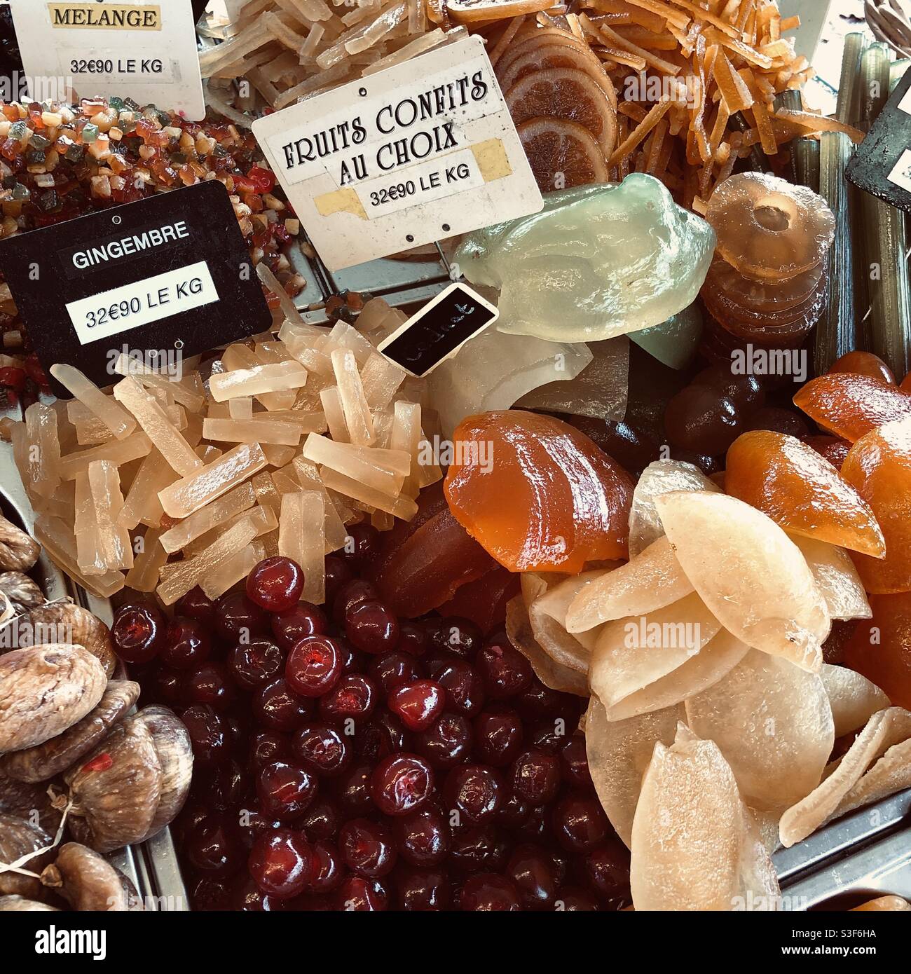 Display of seasonal Christmas glacé fruits on French market stall. Stock Photo