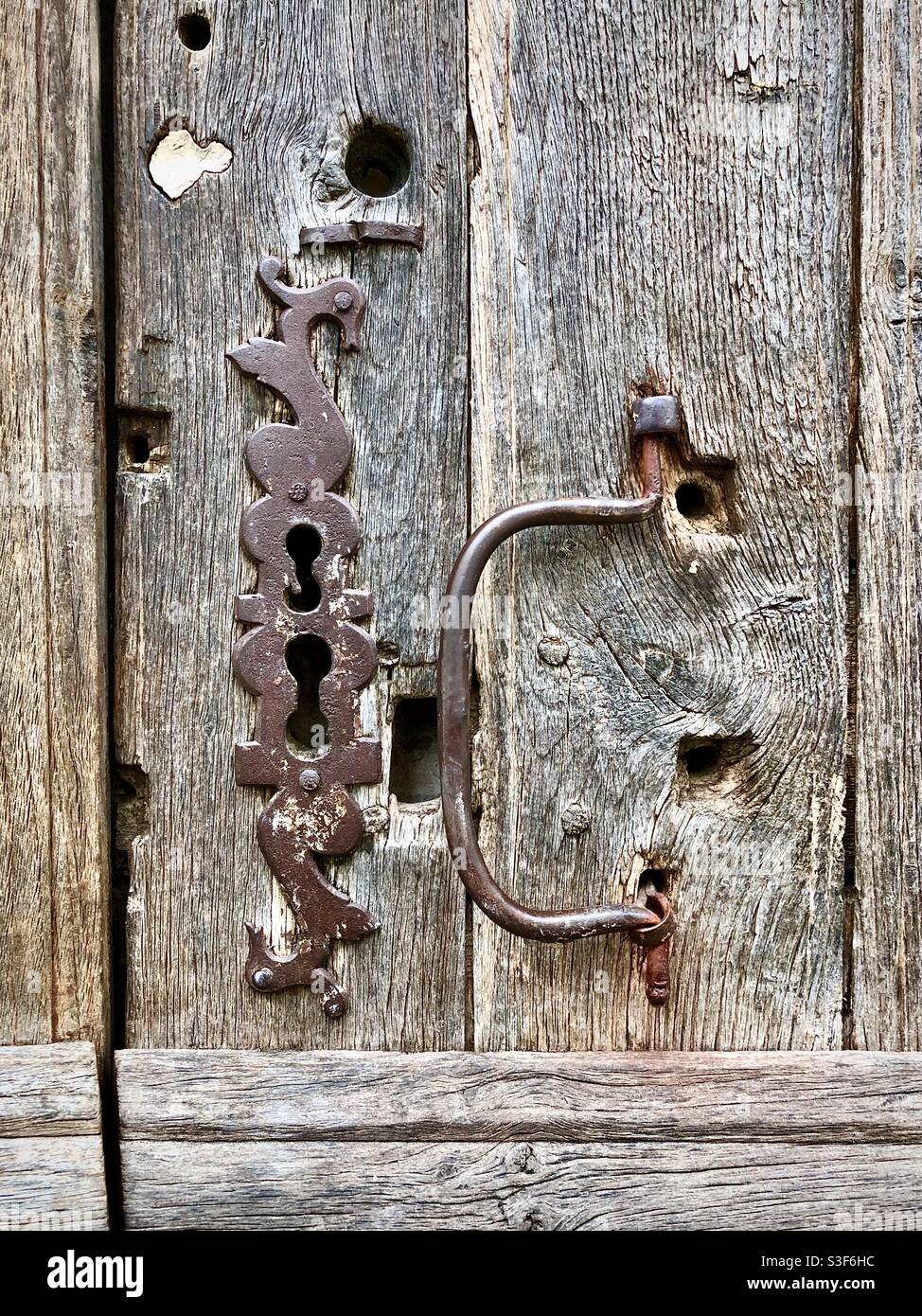 Ancient door lock escutcheon plate on oak door, Loches, Indre-et-Loire, France. Stock Photo