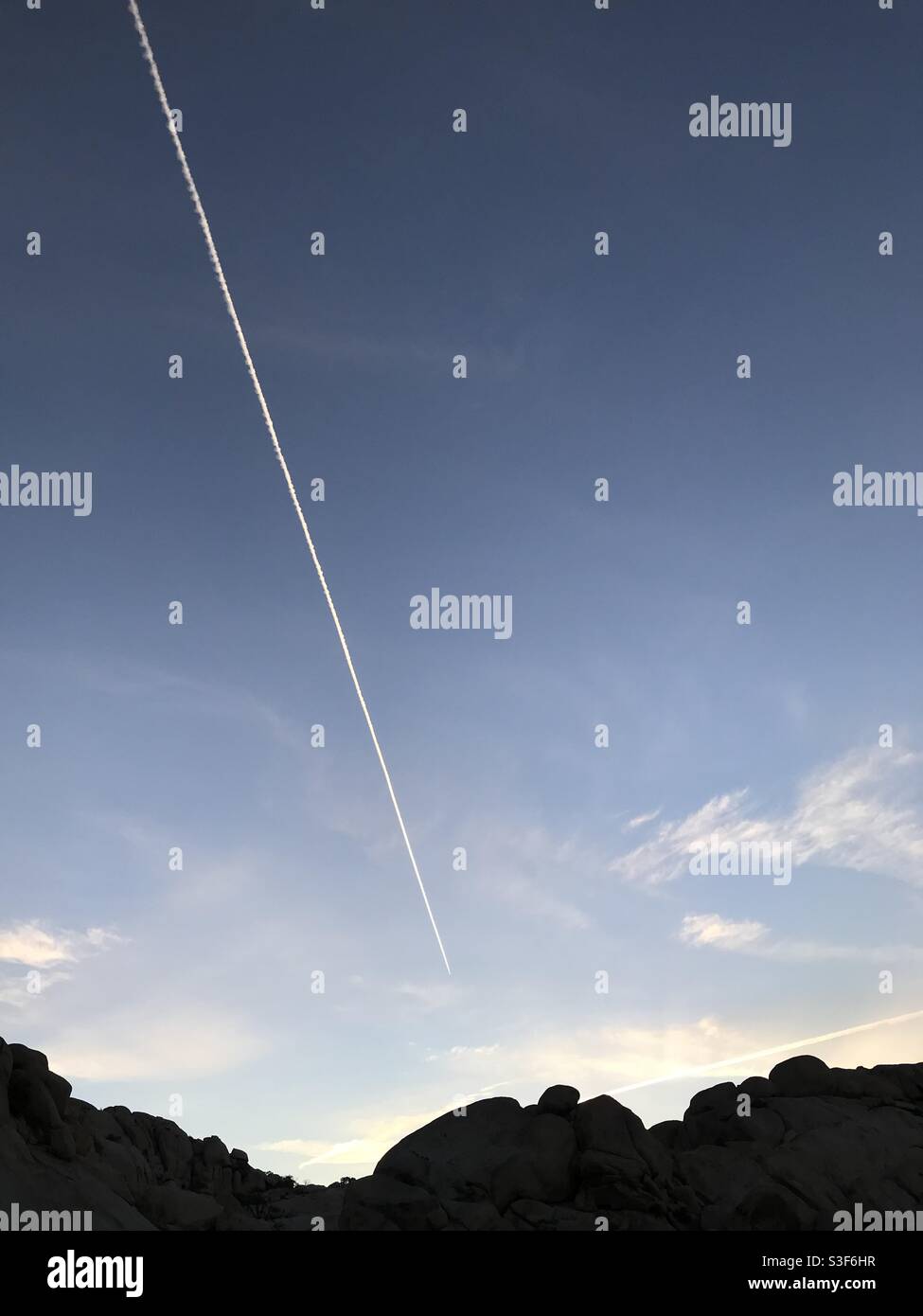 Vapor trail over Joshua Tree National Park, California Stock Photo