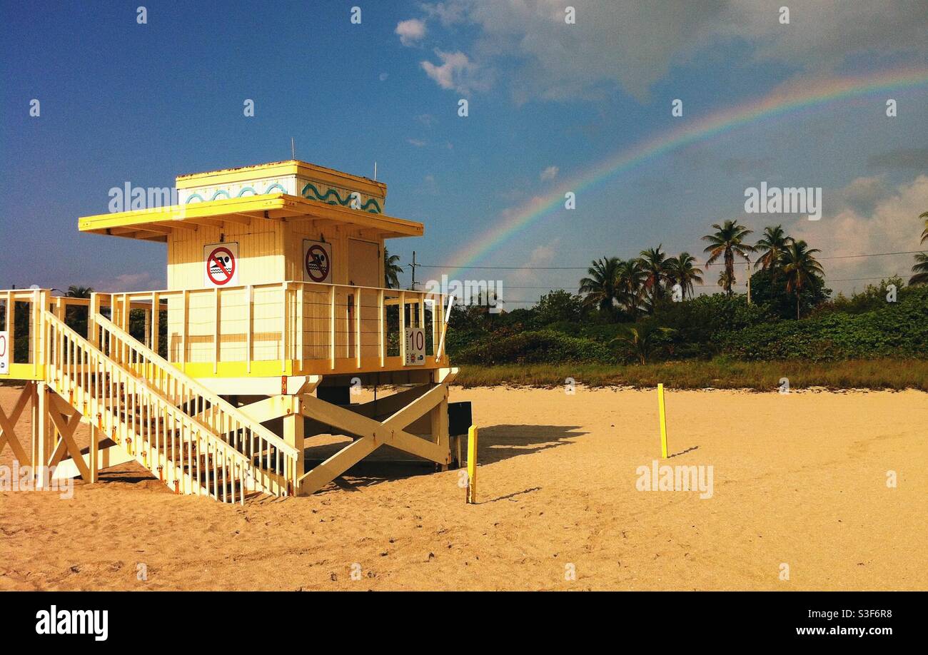 Lifeguard tower on a beach with a rainbow in the background - Smartphone Captured Stock Image
