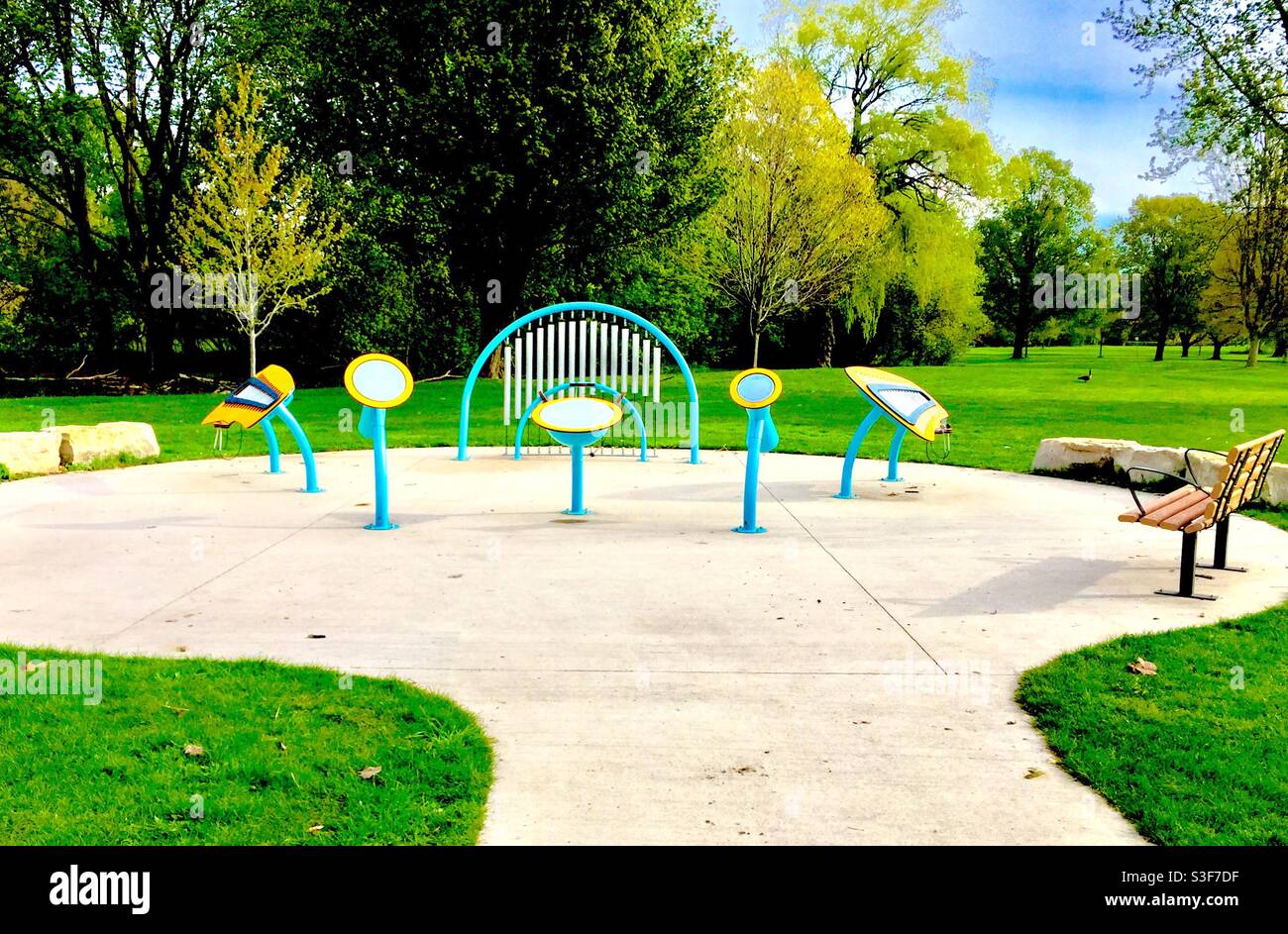 Music in the park. All set in Ontario, Canada. Permanent fixtures in this corner of a big green space. Children big and small bang away at these instruments all day long. - Smartphone Captured Stock Image