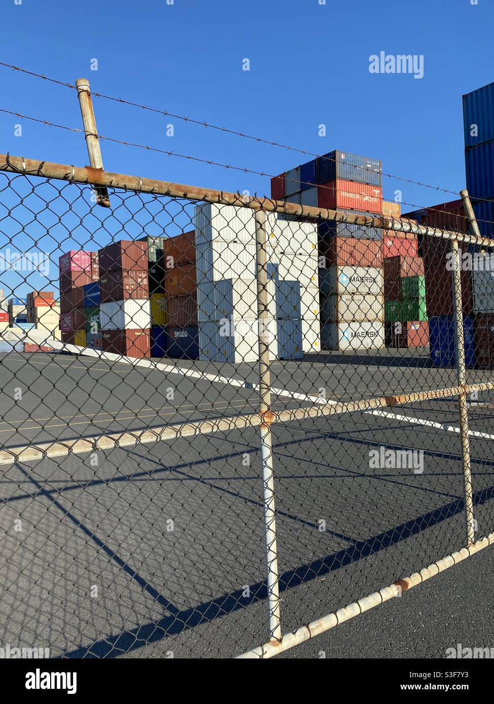 Stacks of shipping containers in a shipyard awaiting customs clearance Stock Photo