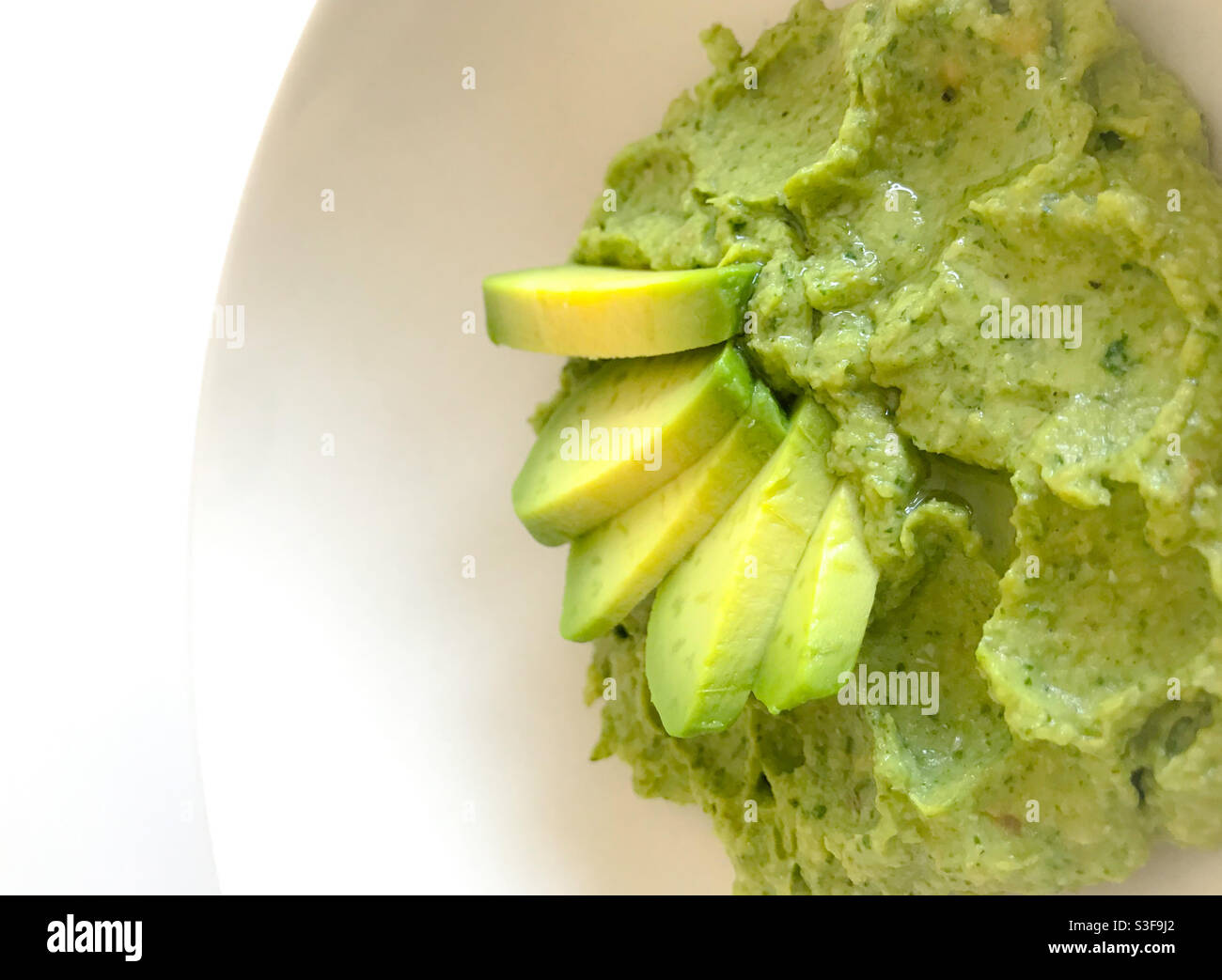 Still Life Avocado Guacamole served in a white plate - Food Photography - Smartphone Captured Stock Image