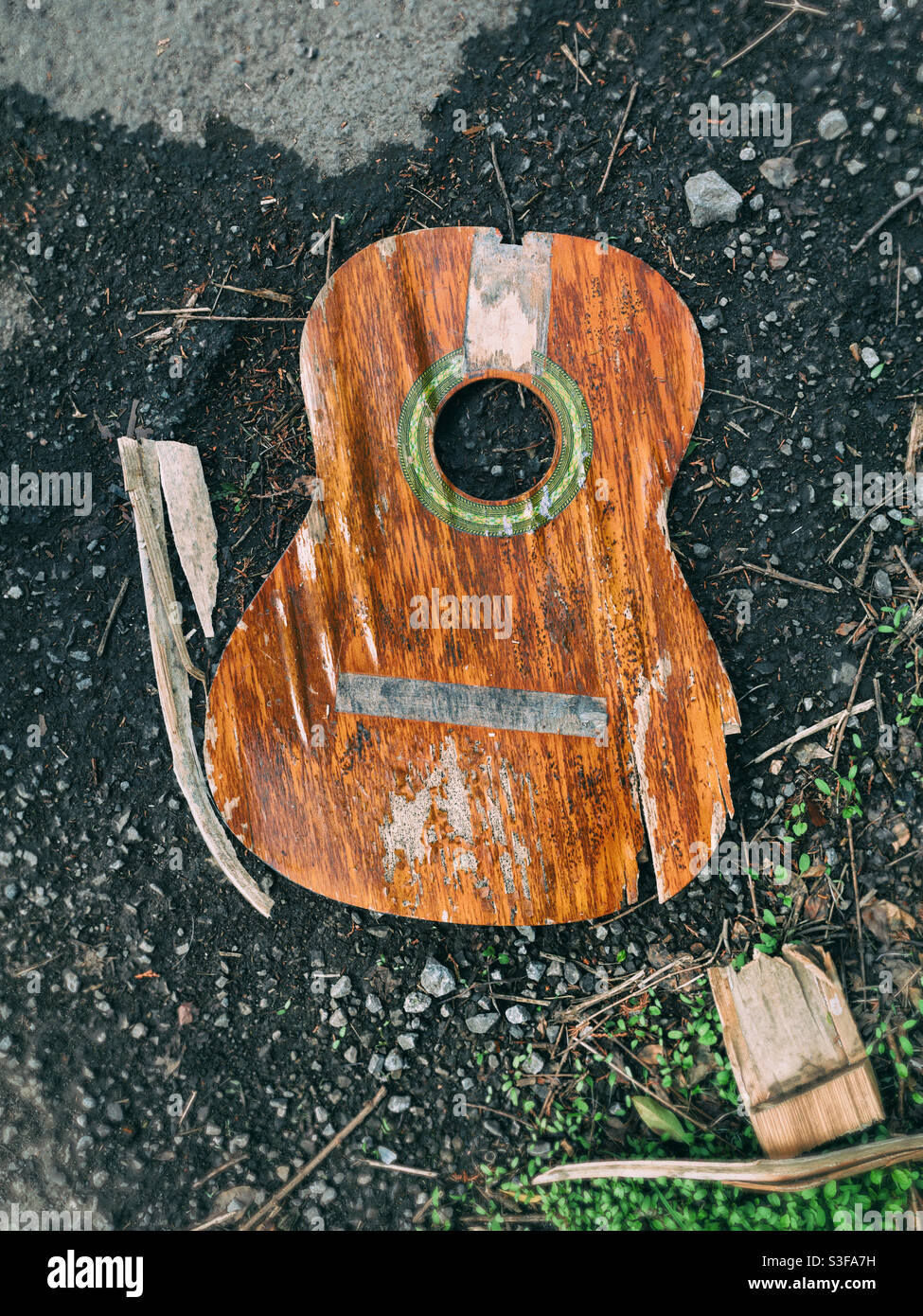 Broken part of a guitar on the floor - Smartphone Captured Stock Image