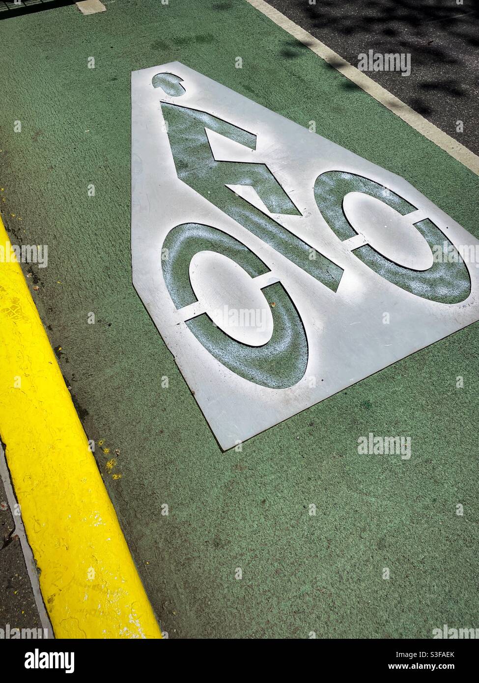 Painted stencil marking a bike lane on a New York City Street, USA - Smartphone Captured Stock Image