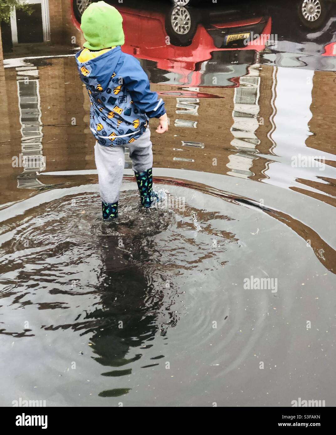 Boy in deep puddle Stock Photo Alamy