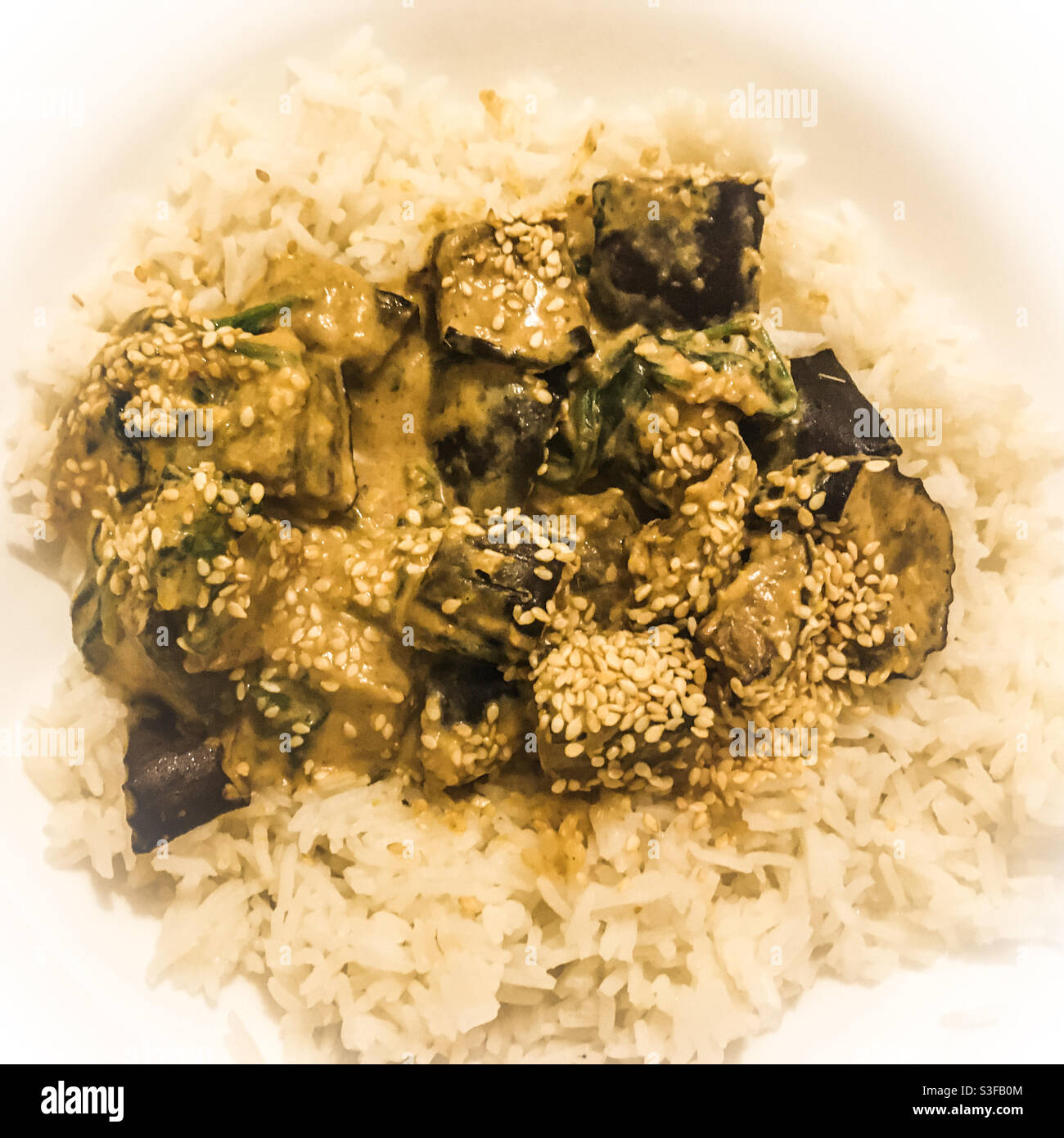 Aubergine Thai massaman curry with sesame seeds and basmati rice Stock Photo