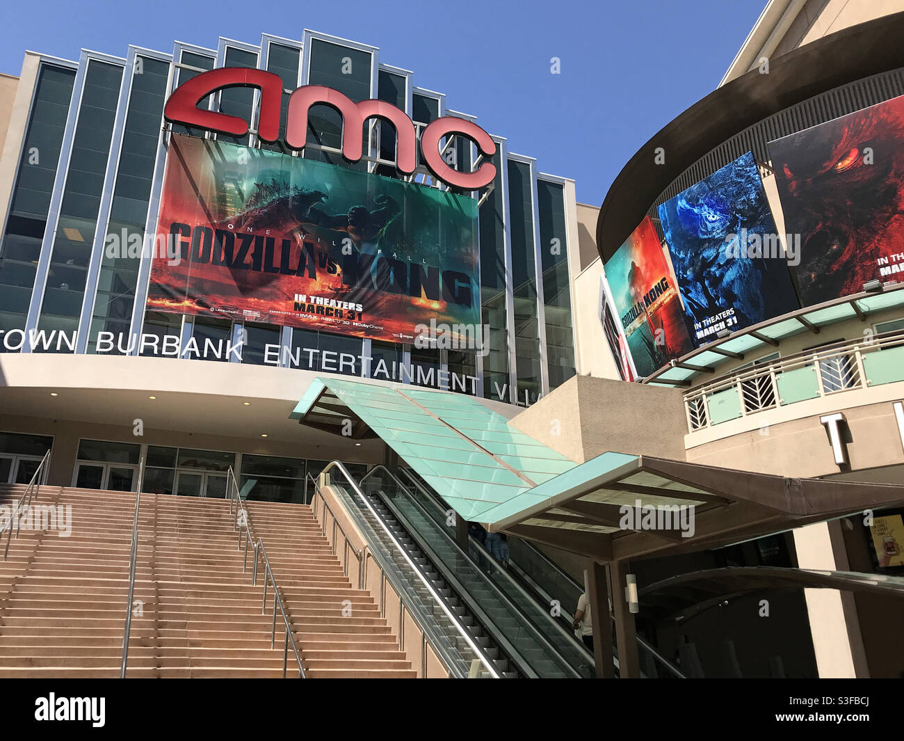 Burbank, CA / USA - March 28, 2021: An AMC movie theater, located in the Downtown Burbank Entertainment Village, is shown promoting Godzilla vs. Kong. The chain recently opened with limited capacity. Stock Photo