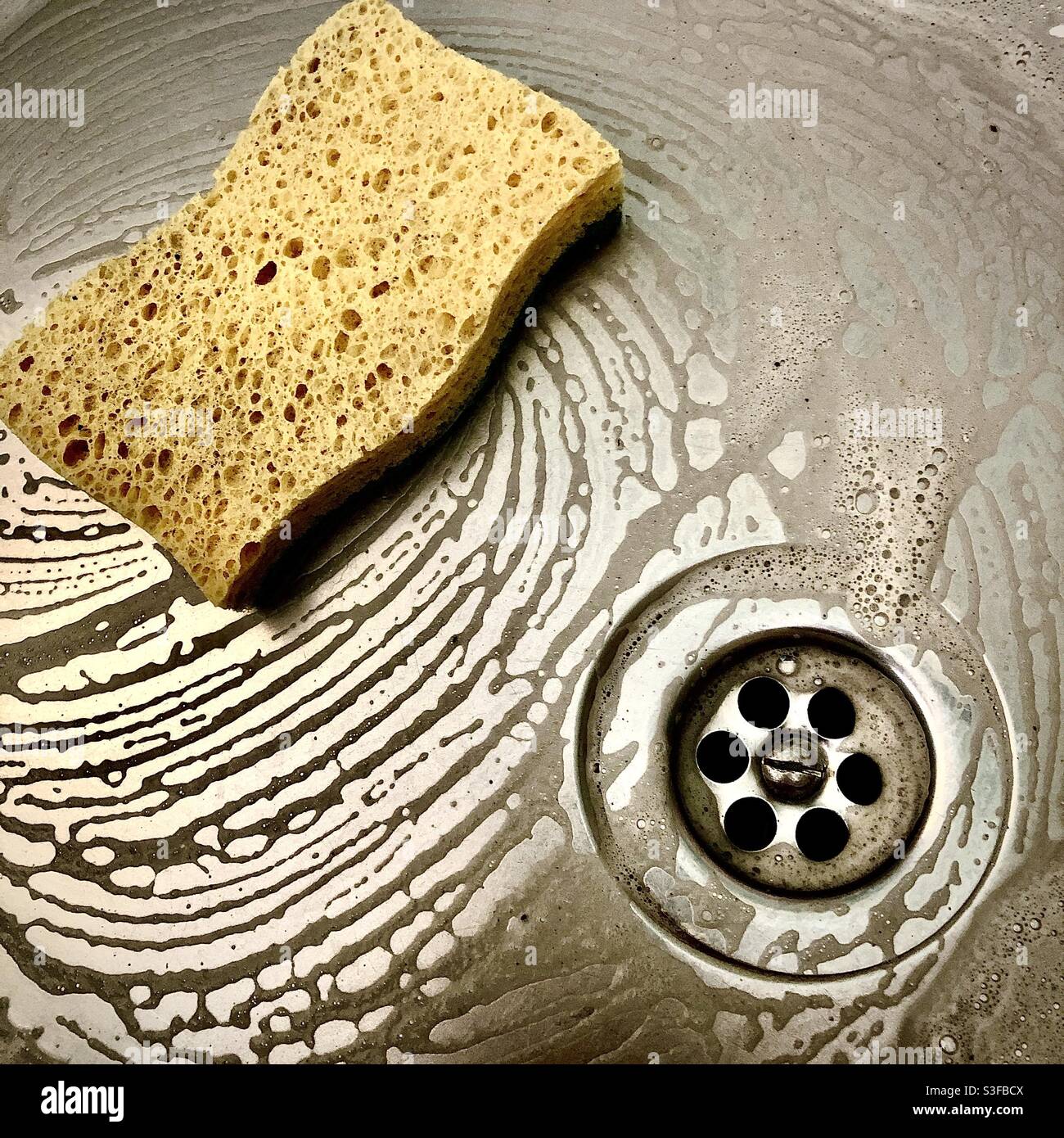 Cleaning stainless steel kitchen sink. Stock Photo