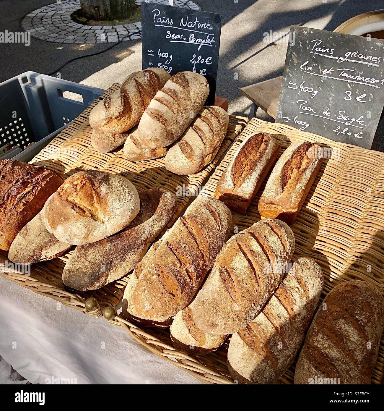 Hand made breads on local market stall - France. Stock Photo