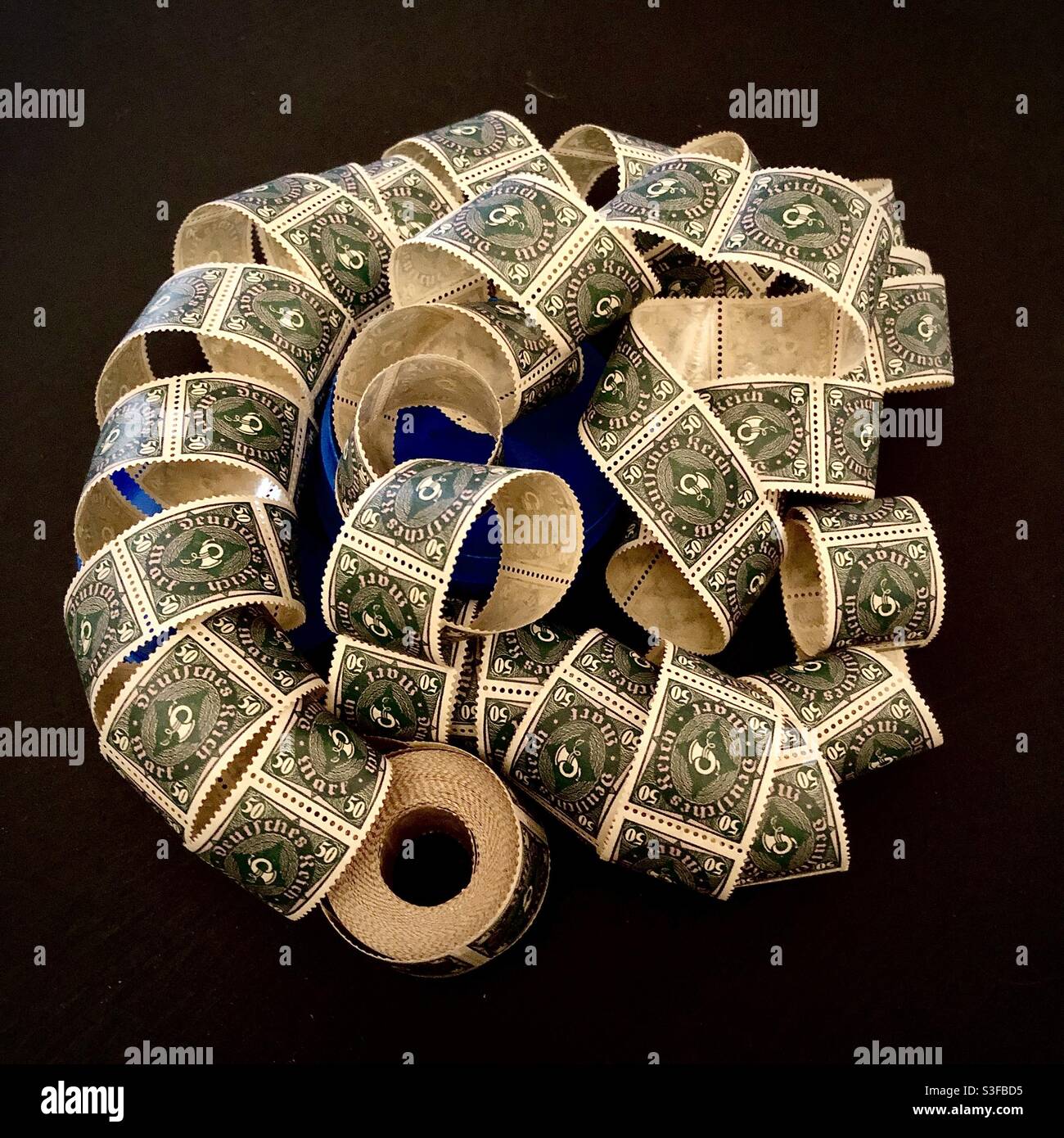 100-year old roll of German 50 Mark stamps for automatic stamp dispenser. Stock Photo