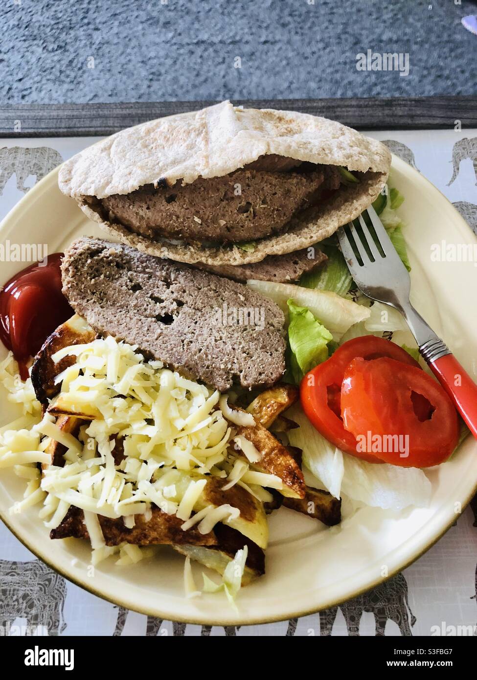 Fakeaway kebab, cheesy chips and salad dinner Stock Photo Alamy