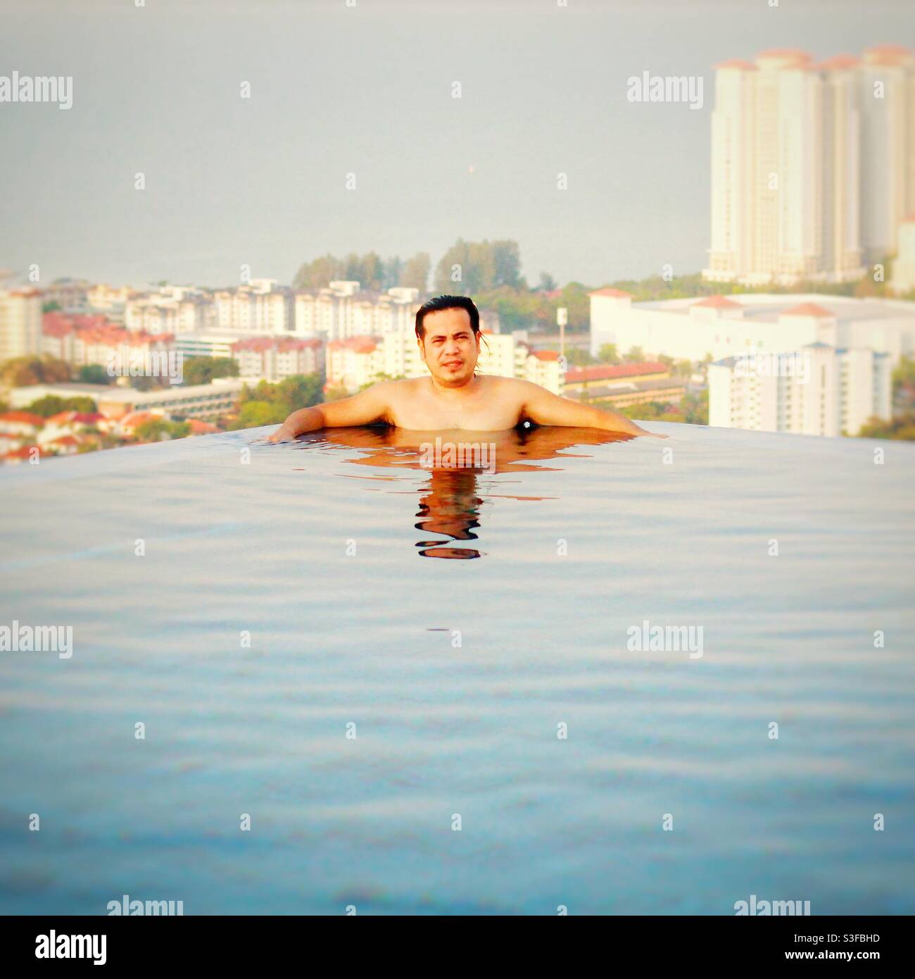 A portrait of myself in the pool at the roof top at 47th floor high rise building. Stock Photo