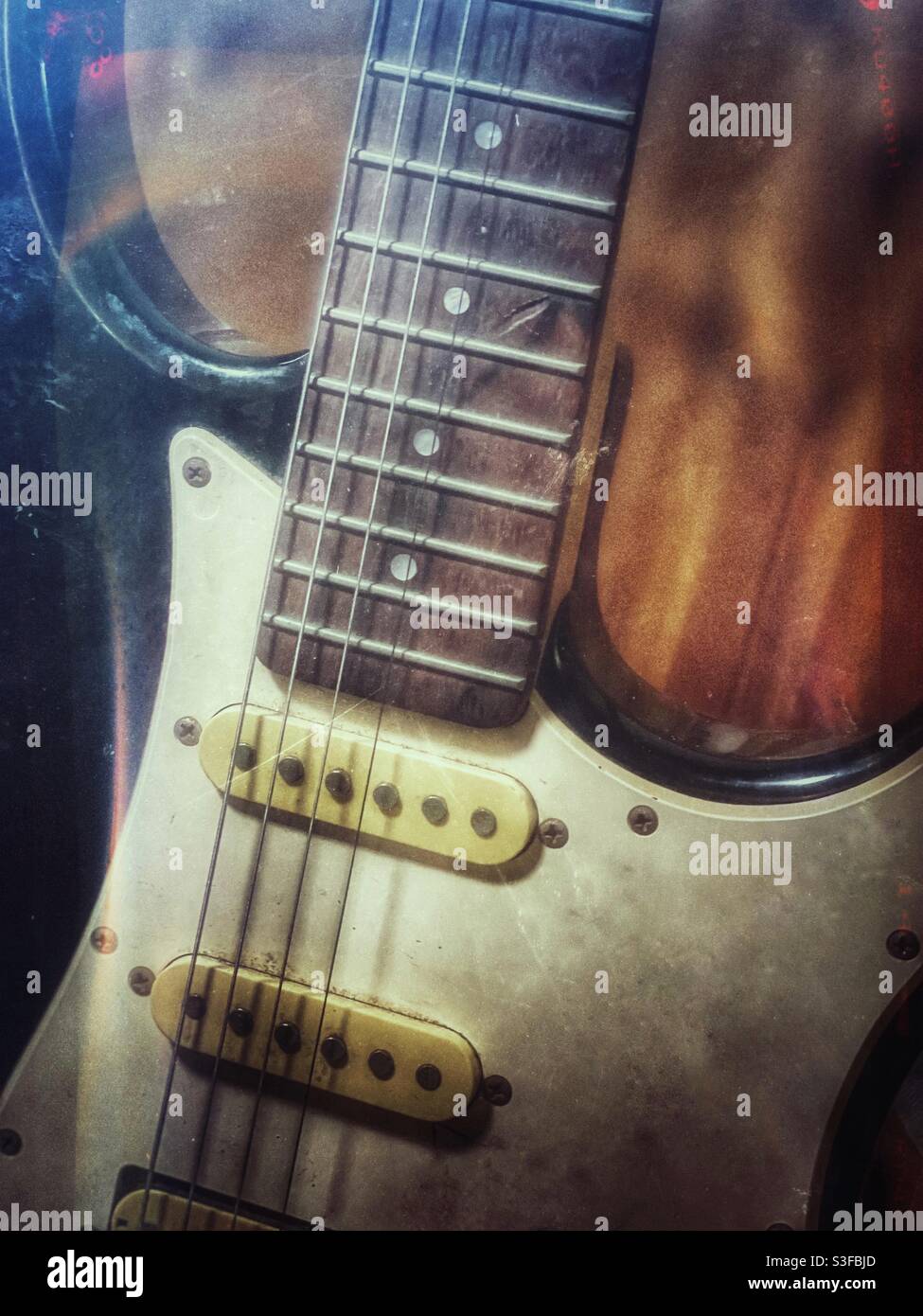 Beat up old electric guitar with grunge and light leak film effects Stock Photo