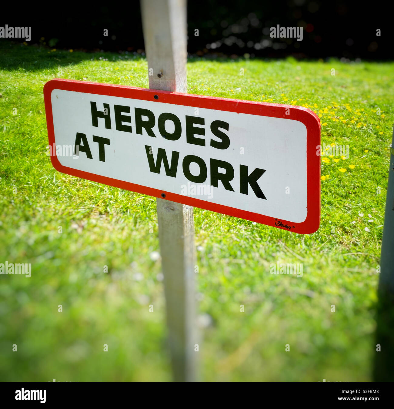 “HEROES AT WORK” sign outside a British hospital. Acknowledgement that NHS workers are Heroes, especially during the Coronavirus Pandemic. Photo Credit - ©️ COLIN HOSKINS. - Smartphone Captured Stock Image