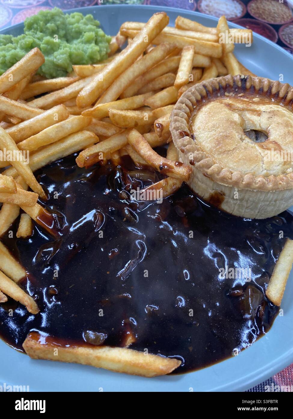 Meat Pie, Fries, Mushy Peas and hot Onion Gravy Stock Photo Alamy