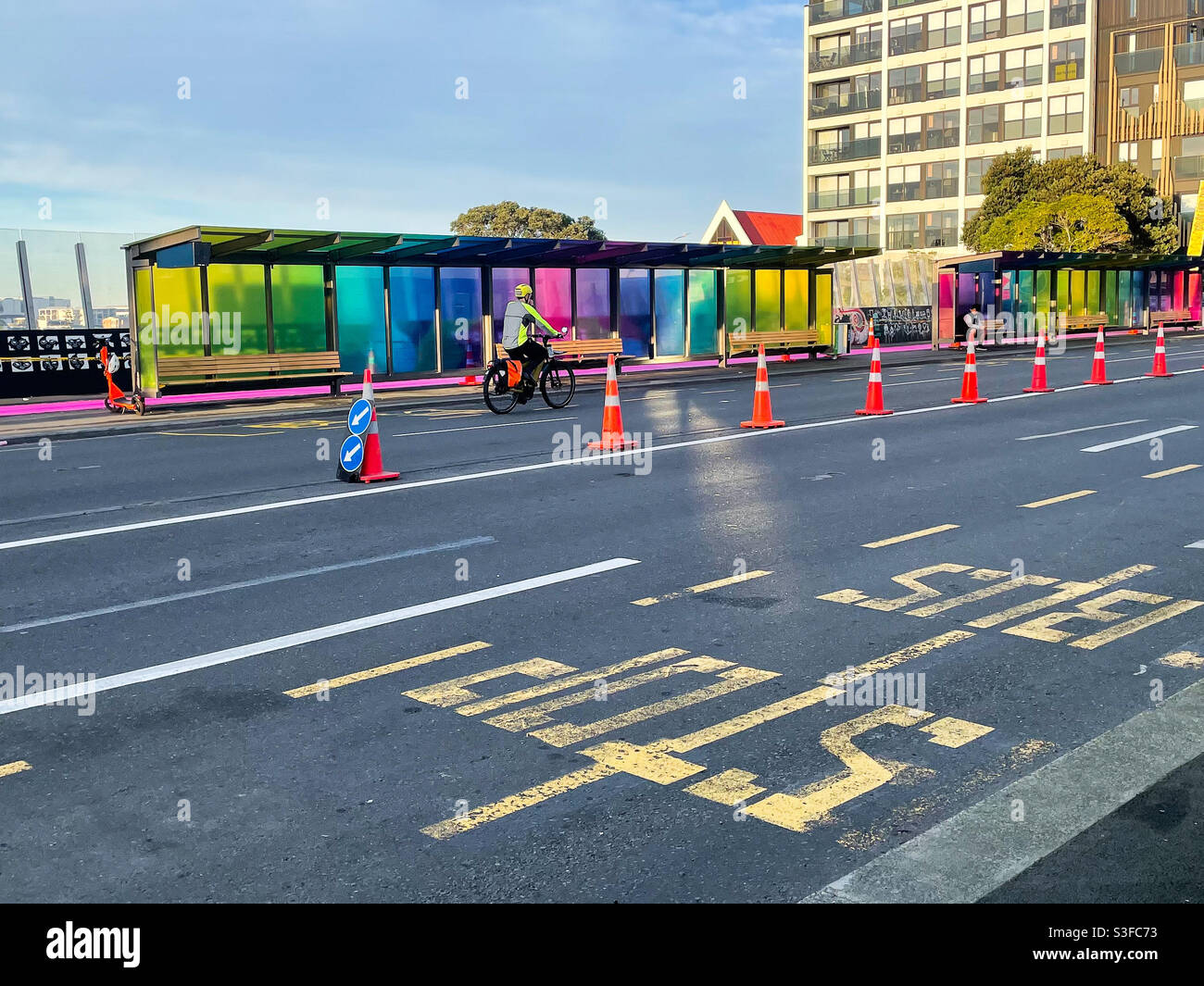 A cyclist rides along the Karangahape Rd over bridge in Auckland, New Zealand Stock Photo
