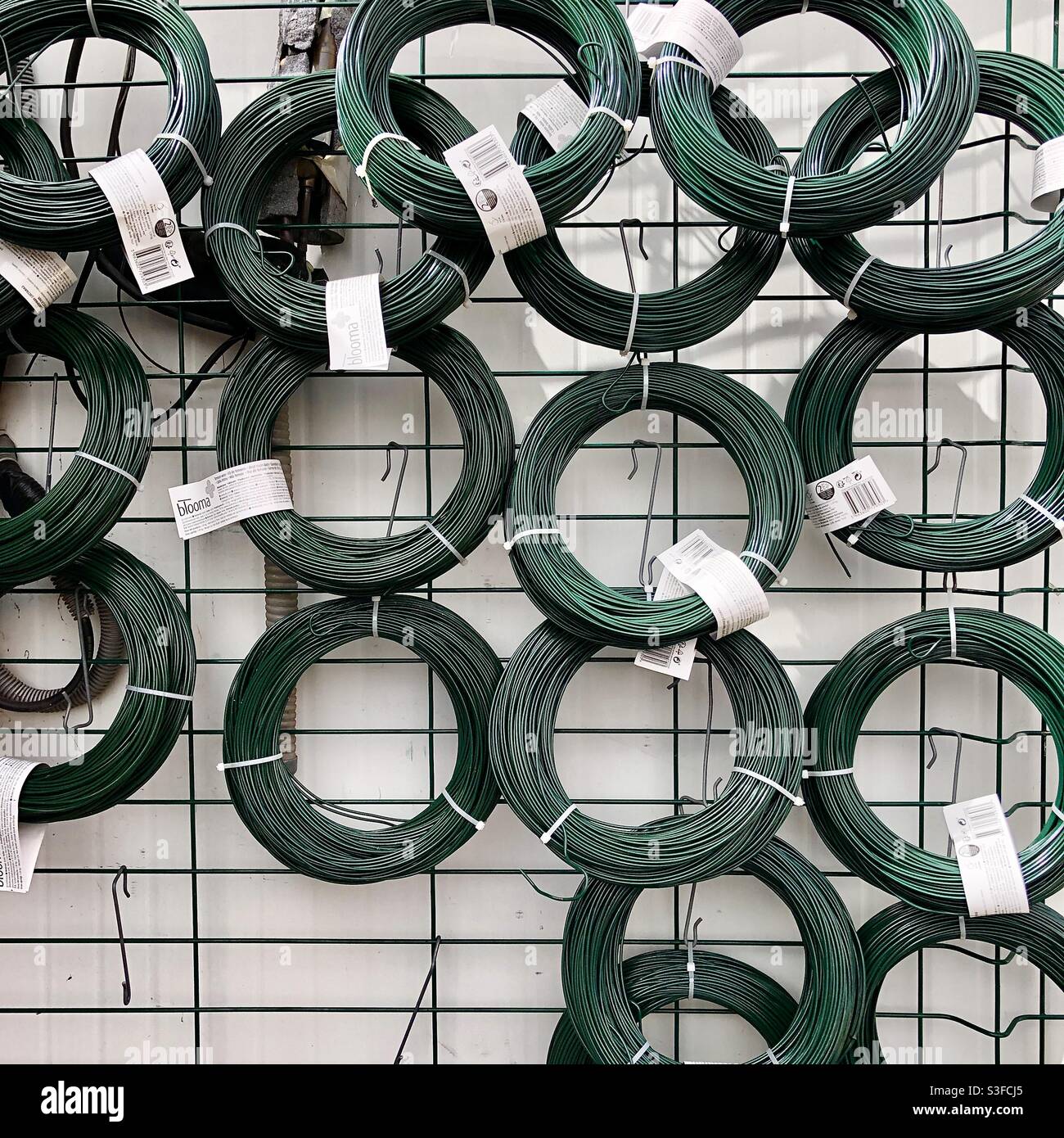 Display rack of plastic covered garden wire. Stock Photo