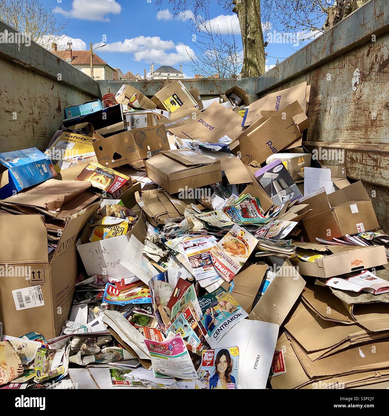 Half full recycling paper skip - France. Stock Photo