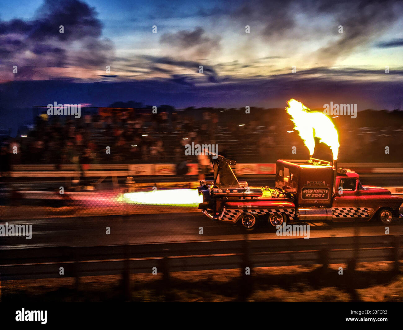 Hayden Proffitt II in his twin Jet Engines Jet Truck  Hot Streak II 1957 Chevy Pickup-Bodied vehicle at night going down the dragstrip at Mo-Kan Dragway in Asbury, Missouri Stock Photo