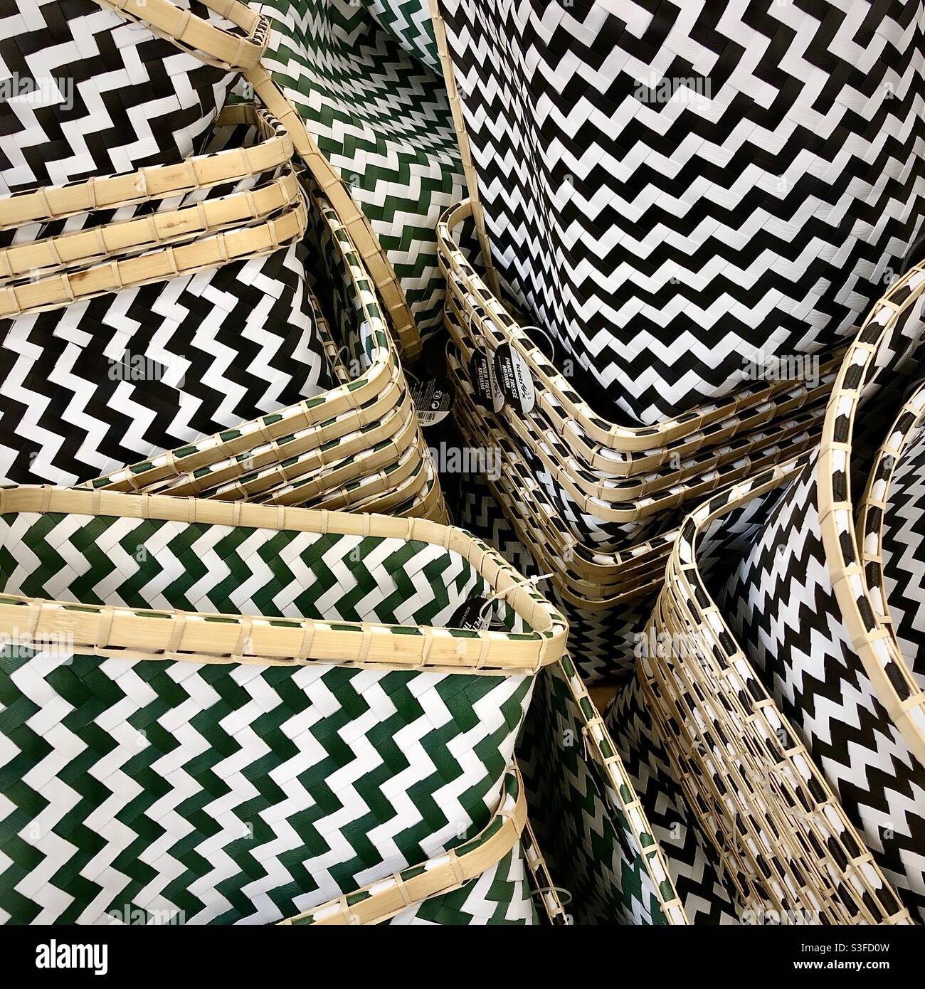 Stack of open-topped receptacles or boxes with graphic zig-zag pattern decoration. Stock Photo